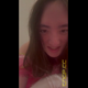 Emi dresses as Princess Peach in a pink gown and white gloves, lifts her dress and bends over to bake a delicious cake for Mario, smiling for the camera. Vertical format video. Over 11 minutes.